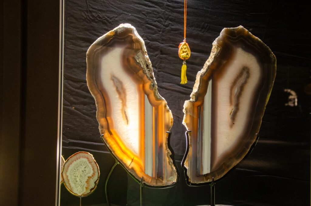 Two backlit agate slices on black stands, crystals in interior design at the Fe2 Crystals gallery