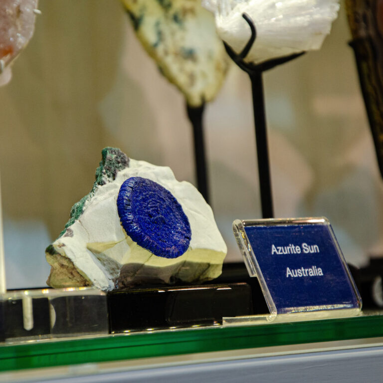 Azurite sun, a round blue disc on white rock, beside a label naming Australia as its origin