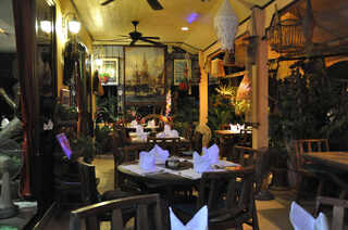 Le Celtique garden dining room with rattan lanterns and plants, Phuket