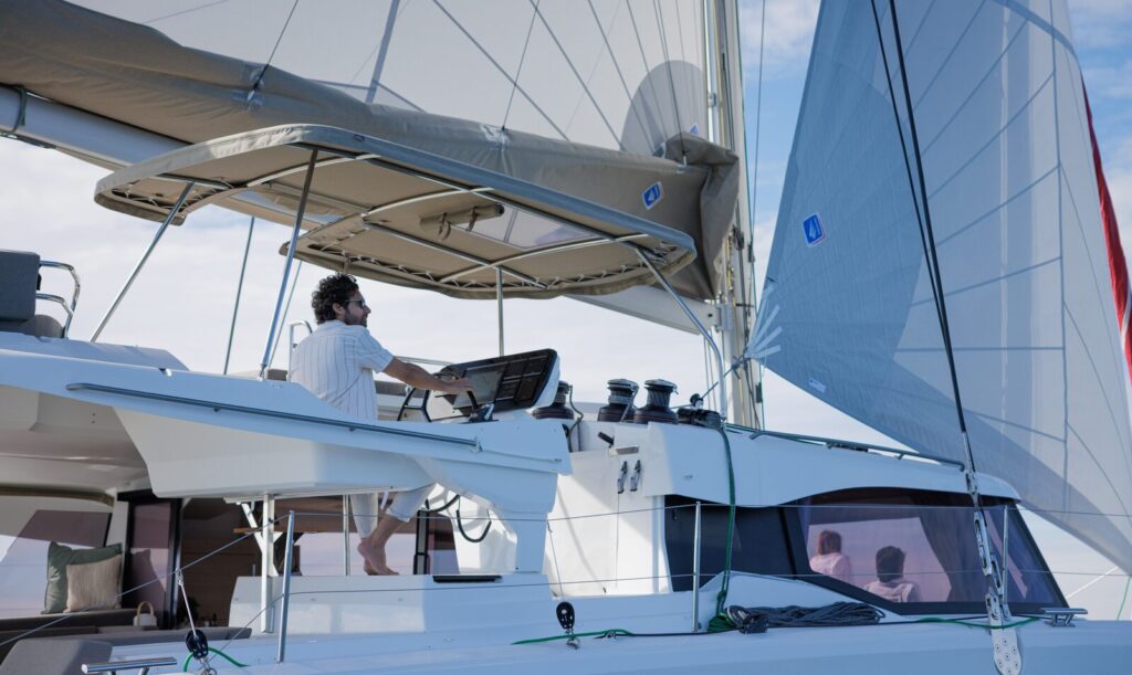 Helm and sails of a sailing catamaran
