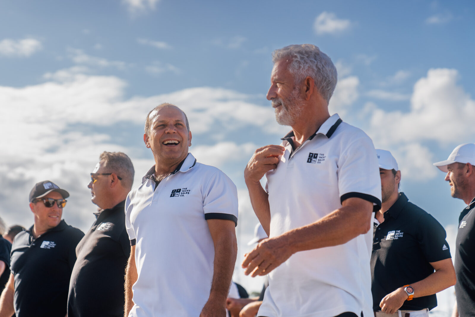 Two Yacht Sales Co. brokers talking outdoors