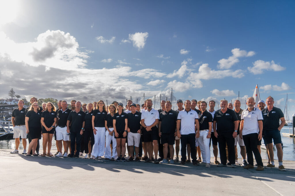 The Yacht Sales Co. team gathered on the marina quay