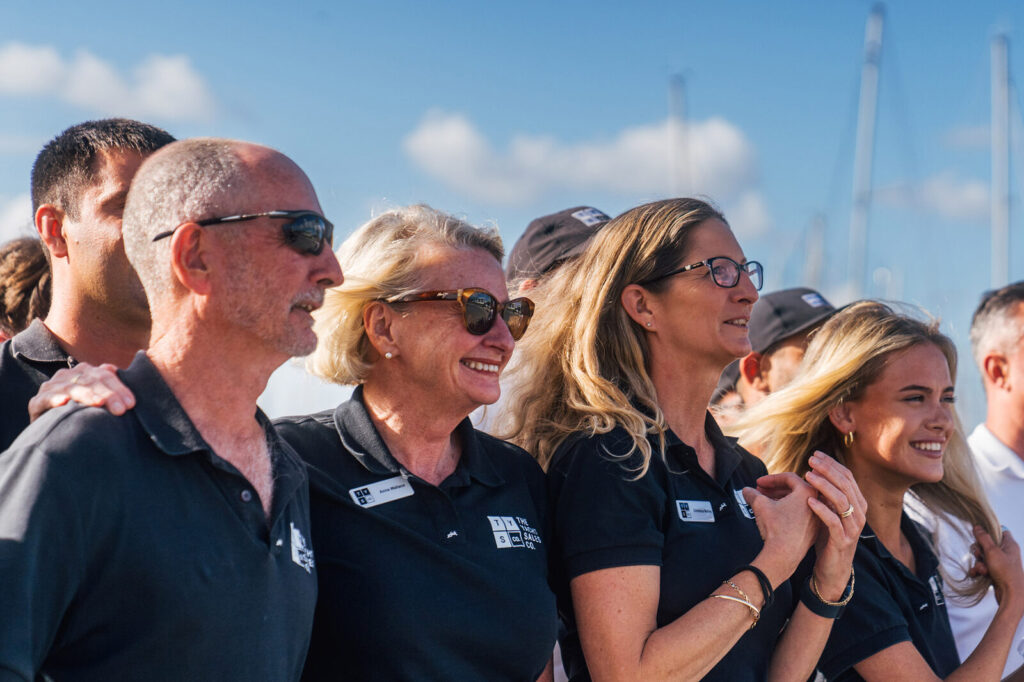 Members of The Yacht Sales Co. team smiling together at an event