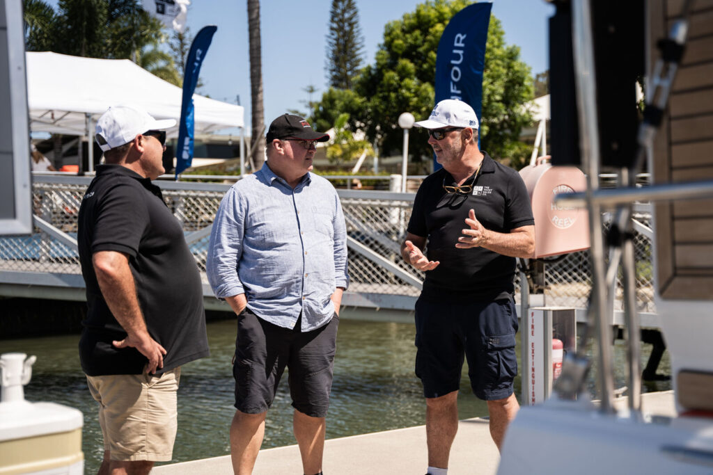 Brokers talking with visitors on a marina pontoon